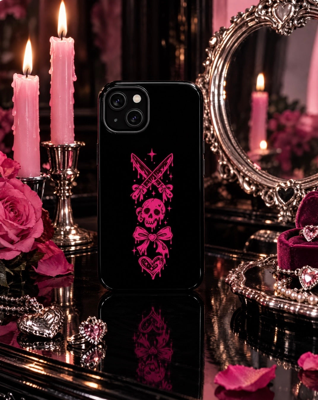 Pink gothic magnetic phone case styled with candles, roses, silver mirror, and jewelry.