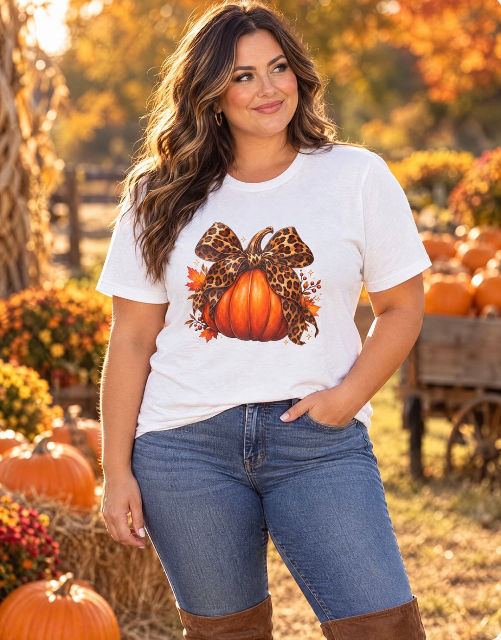 Plus-size model wearing the leopard bow pumpkin fall T-shirt at a pumpkin patch.