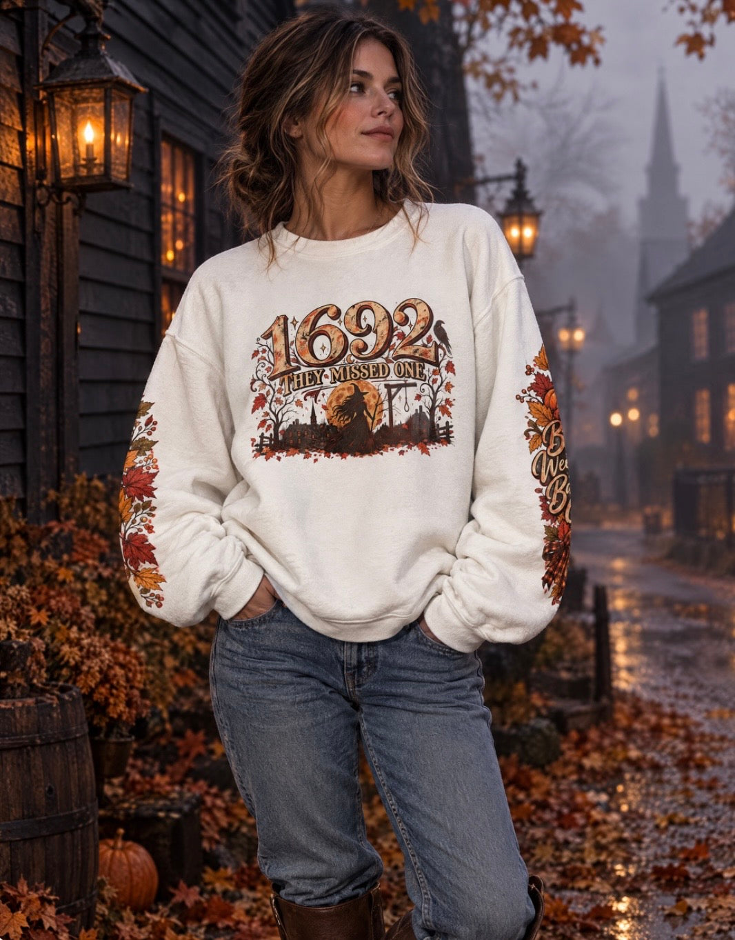 Model wearing the 1692 They Missed One witchy crewneck on a foggy historic autumn street.