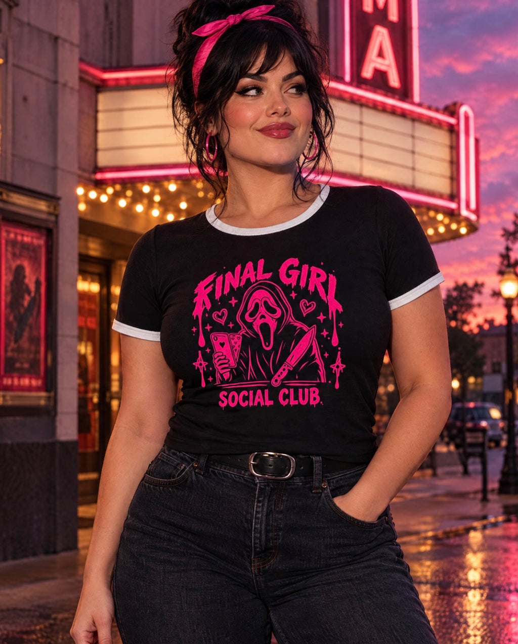 Curvy woman wearing the Final Girl Social Club ringer tee outside a vintage movie theater at sunset.
