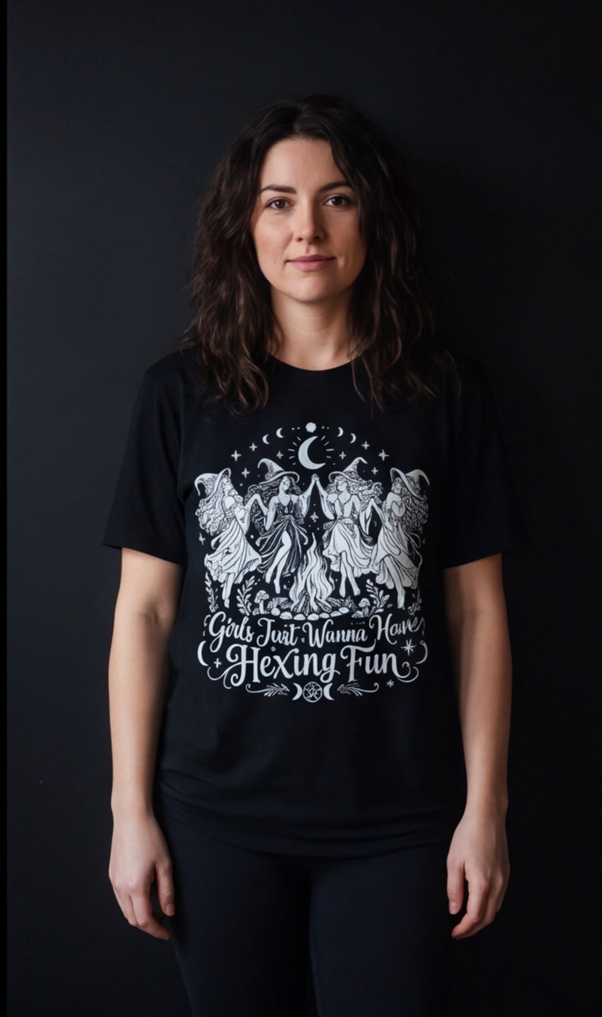 Front-facing model wearing the black Girls Just Wanna Have Hexing Fun witch graphic tee.