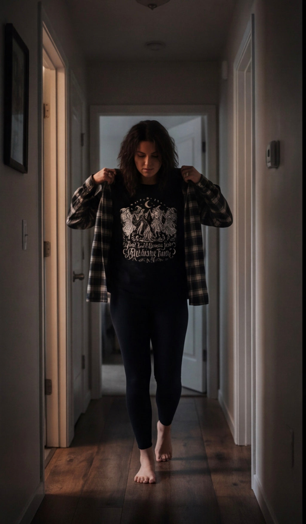 Woman styling the Girls Just Wanna Have Hexing Fun witch tee with a plaid overshirt.