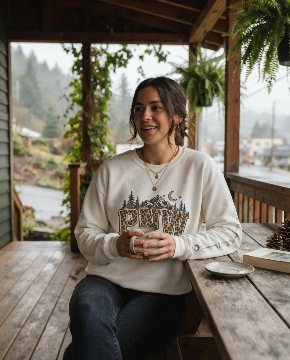 PNW leopard varsity sweatshirt in a cozy Pacific Northwest porch setting
