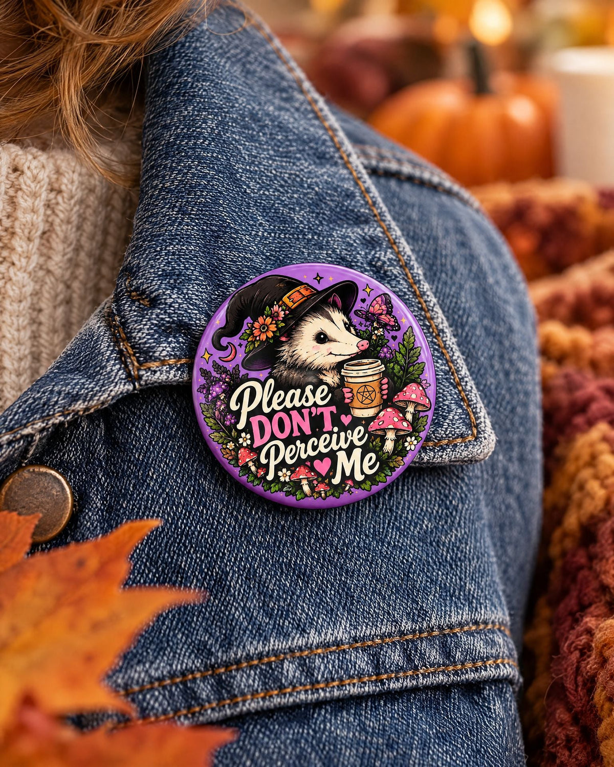 Lifestyle hero mockup of the Please Don't Perceive Me opossum pin.